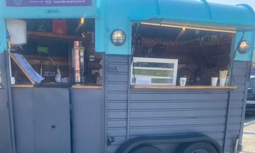Vendor using TapaGo Mobile POS at outdoor market stall