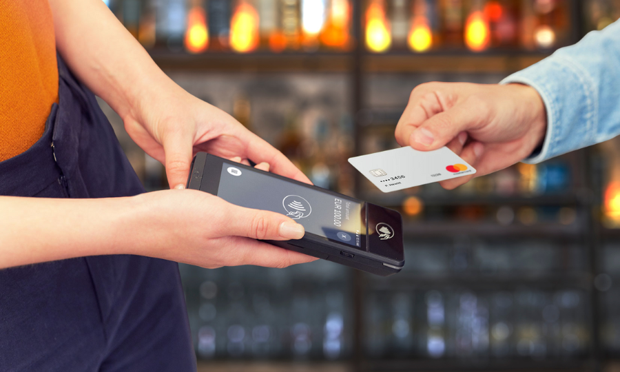 Waiter using TapaGo handheld to take a table order